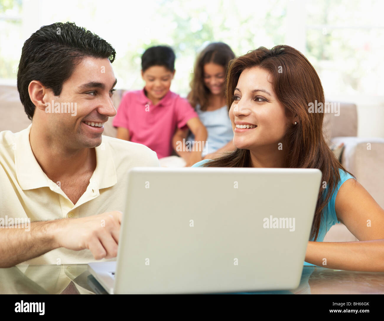 Parents Using Laptop At Home Stock Photo Alamy