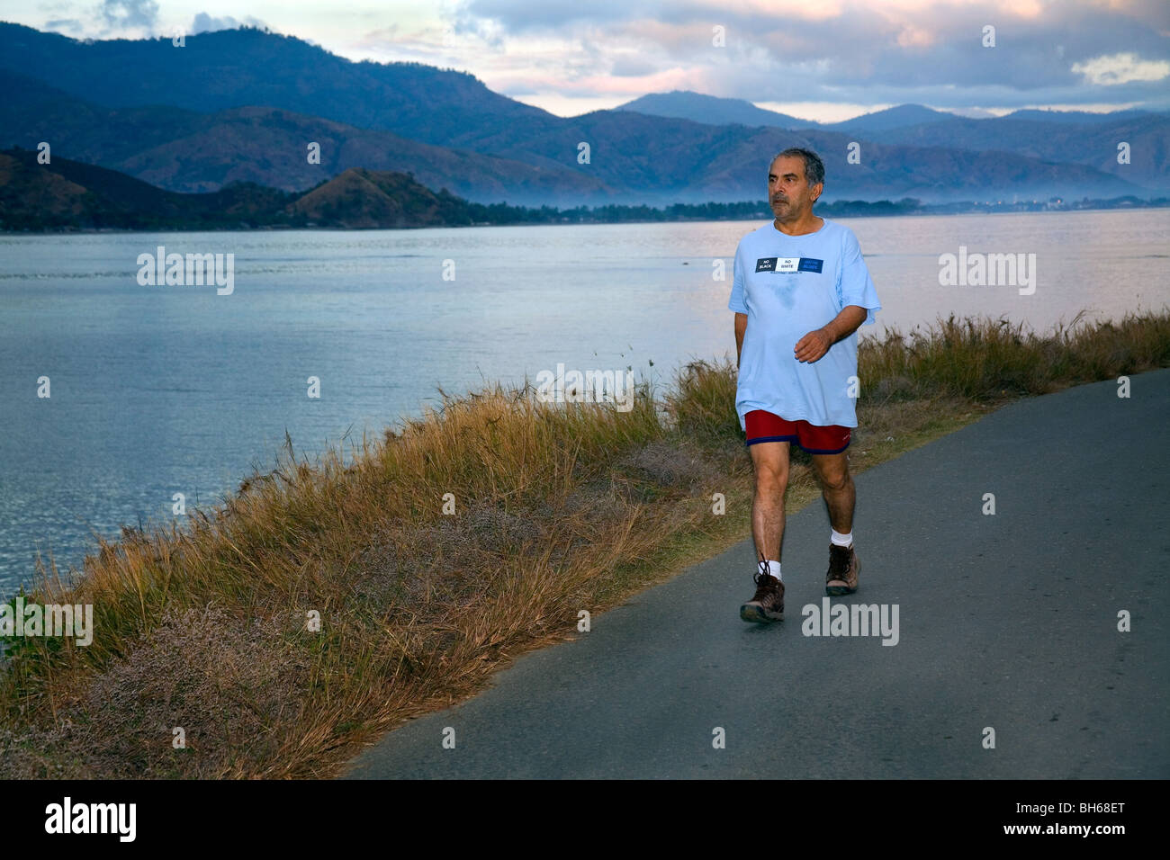 President of East Timor, Jose Ramos-Horta, on his daily pre-dawn keep-fit walk around the east  side of Dili bay . Stock Photo