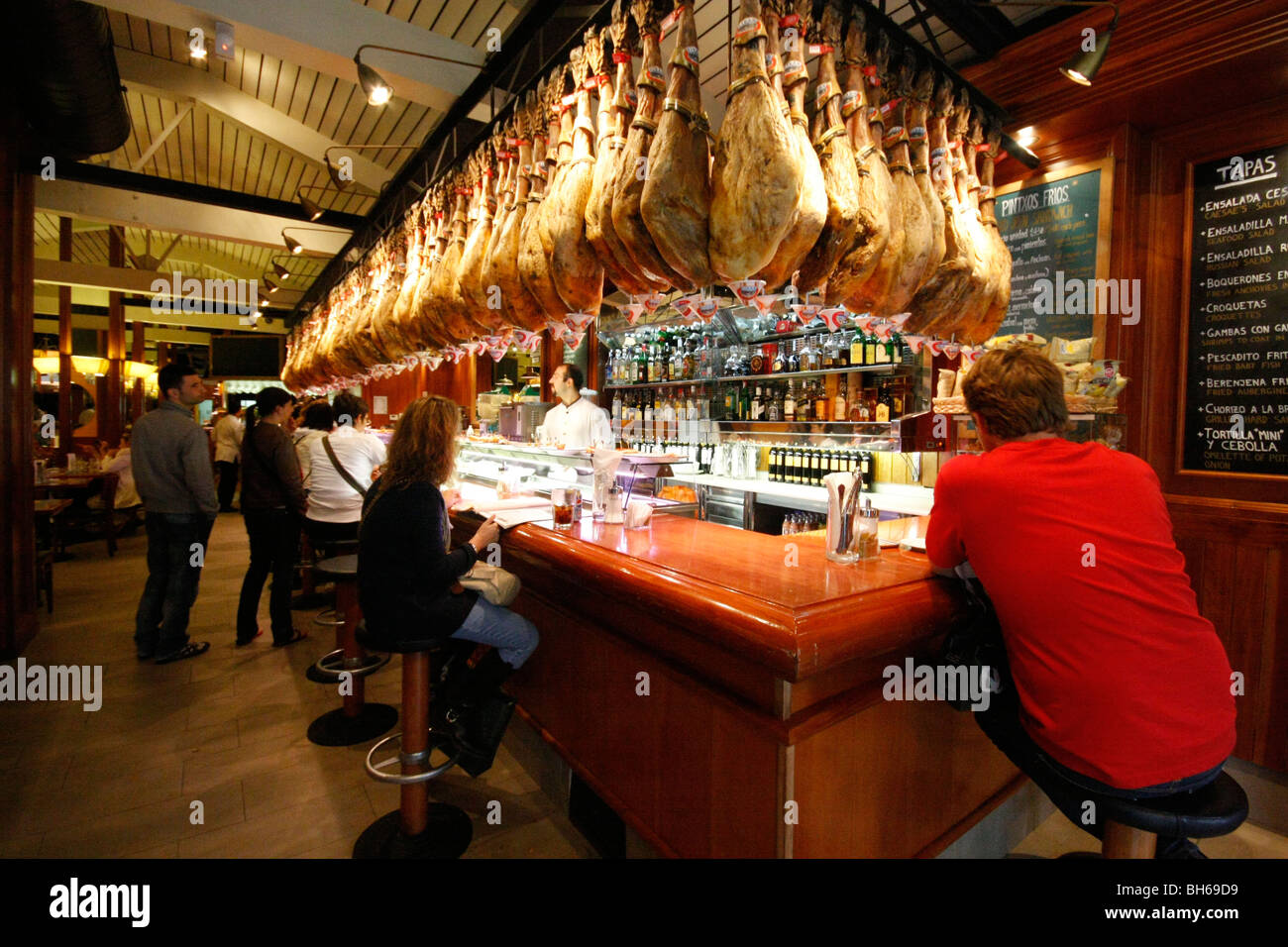 A Tapas bar in Barcelona where meat is hung from the bar counter Stock  Photo - Alamy