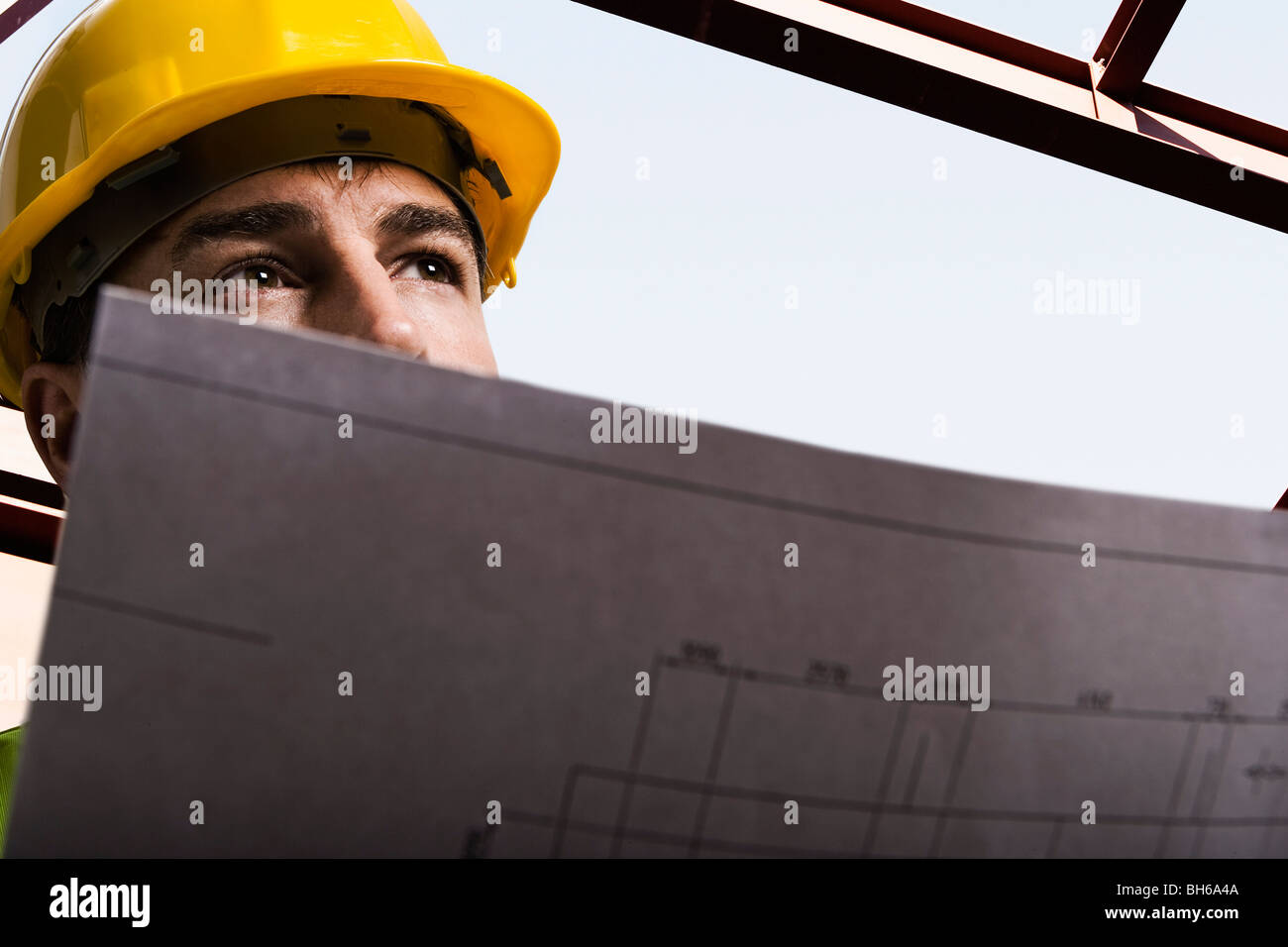 Construction worker holding drawings Stock Photo