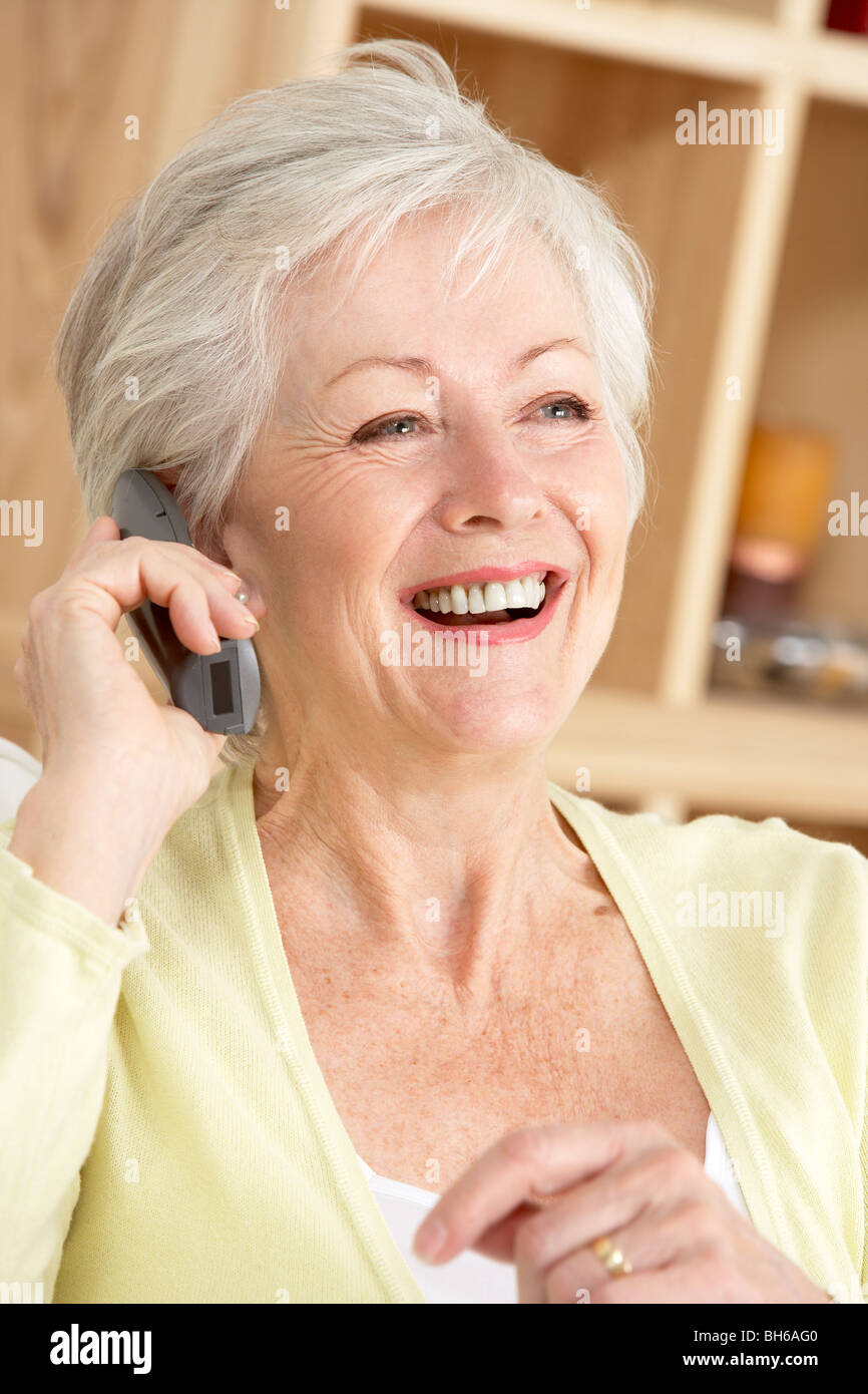 Senior Woman Using Phone At Home Stock Photo