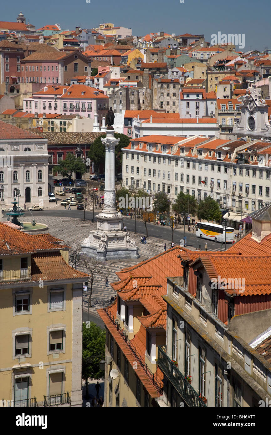View over roofs and down streets to Rossio square and monument Dom Pedro IV, Lisbon, Portugal, Europe. Stock Photo