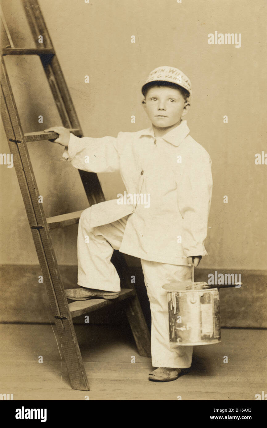 Little Boy Painter Climbing a Ladder Stock Photo