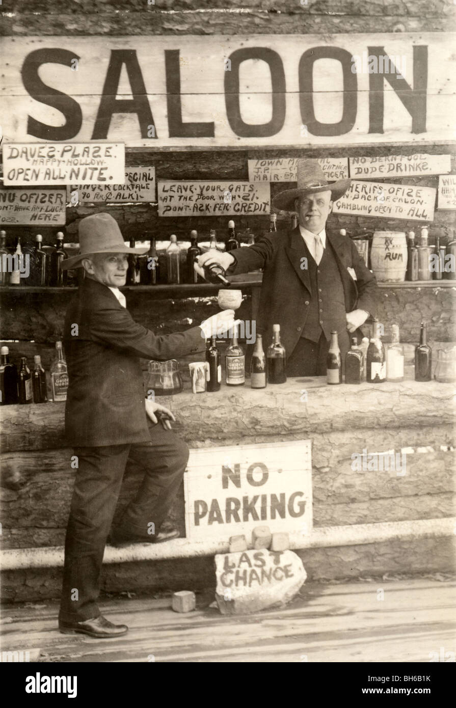 Old Time Saloon with Bartender Pouring Drink Stock Photo