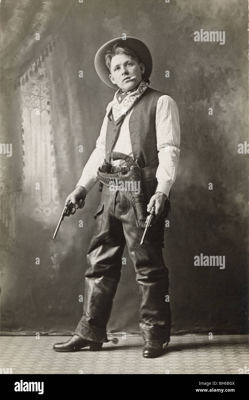 Tough Guy Smoking Cowboy with Pistols Drawn Stock Photo