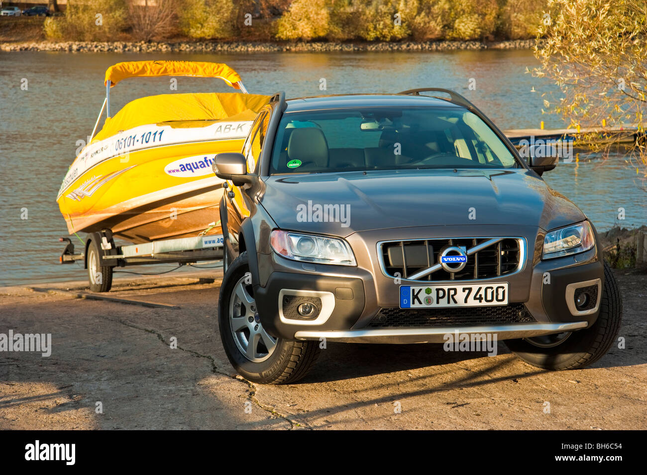Volvo XC 70 towing a yellow ski power boat at Rhine river, Germany Stock Photo