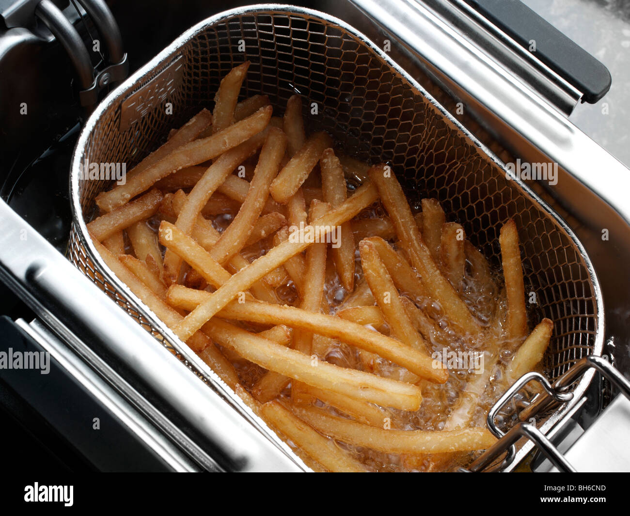 Chips deep fat frying Stock Photo Alamy