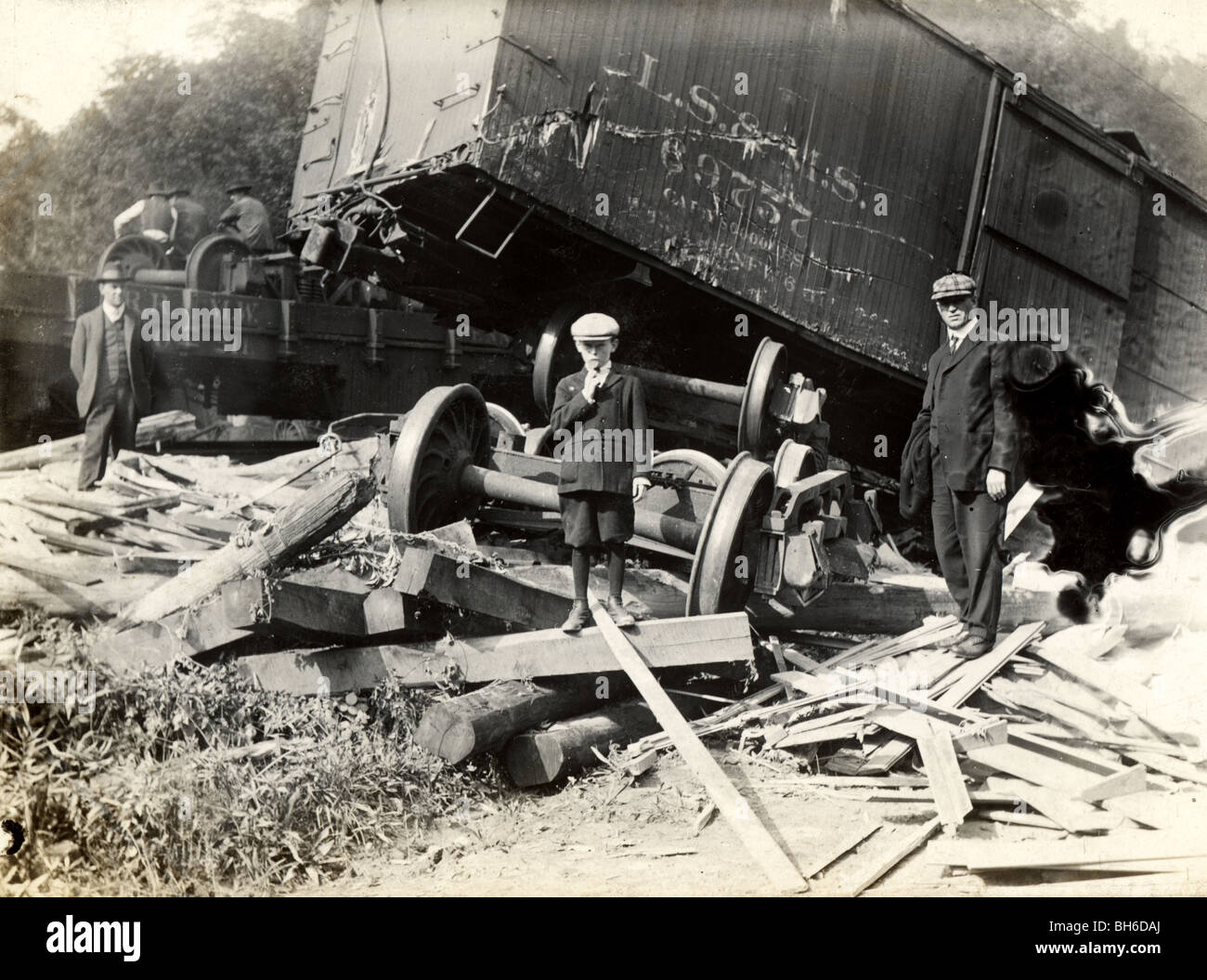 Boy Standing Amidst Wreckage from Train Wreck Stock Photo