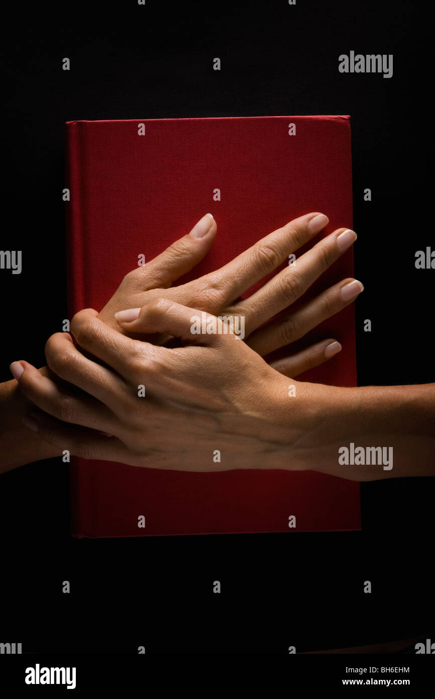 Hands holding book hi-res stock photography and images - Alamy