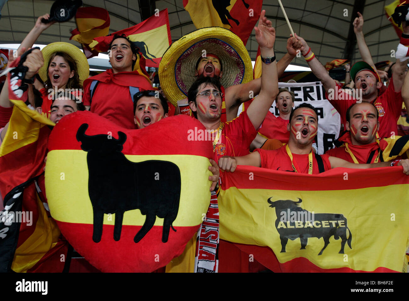Spanish football fans with flags sing in the stands at the 2006