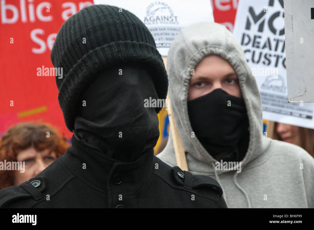National Demonstration against Police Violence in London. Hooded and masked figures in the march with placards Stock Photo