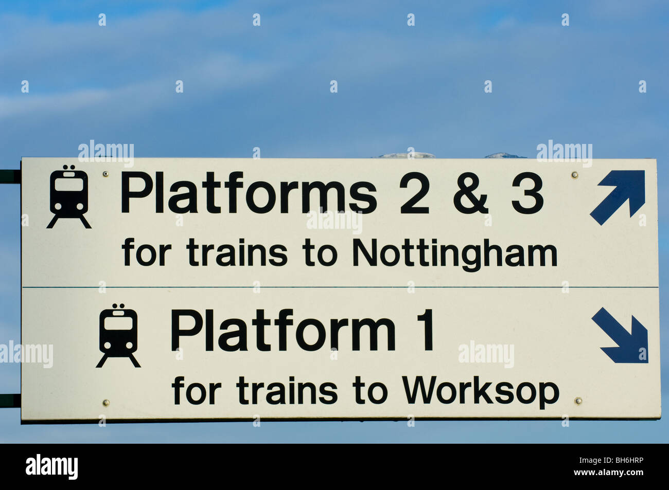 Train station signs pointing to the platform or to the station Stock Photo