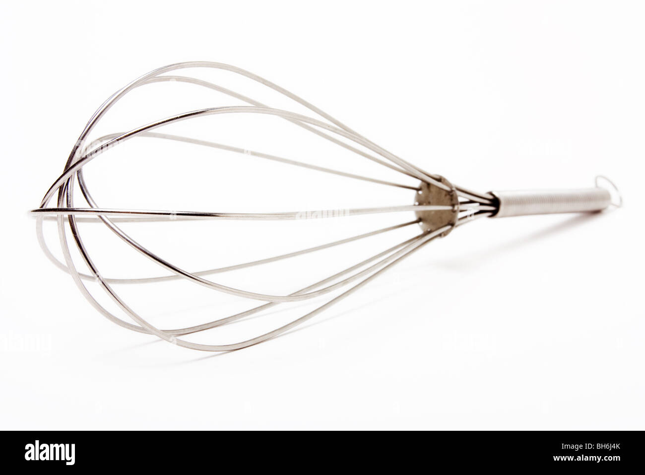 Stainless steel chef's whisk isolated against white background. Stock Photo