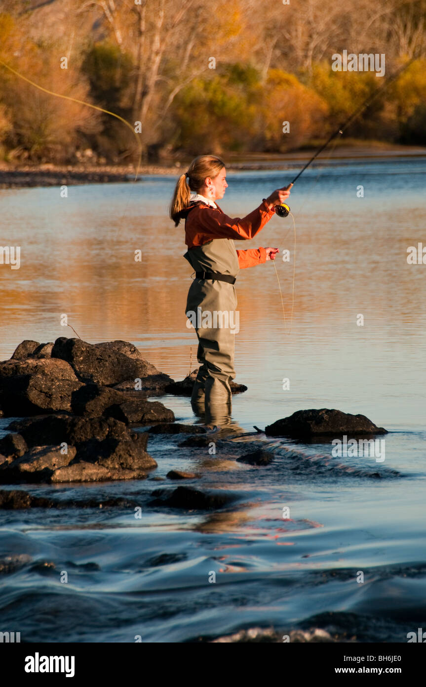 Idaho, Boise, Woman fly fishing on the Boise River with autumn colors