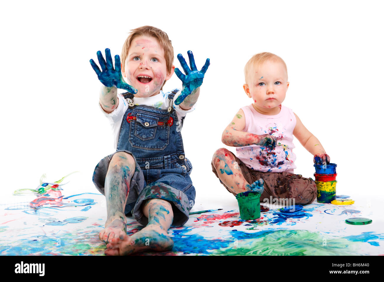 Two kids finger painting on white background Stock Photo
