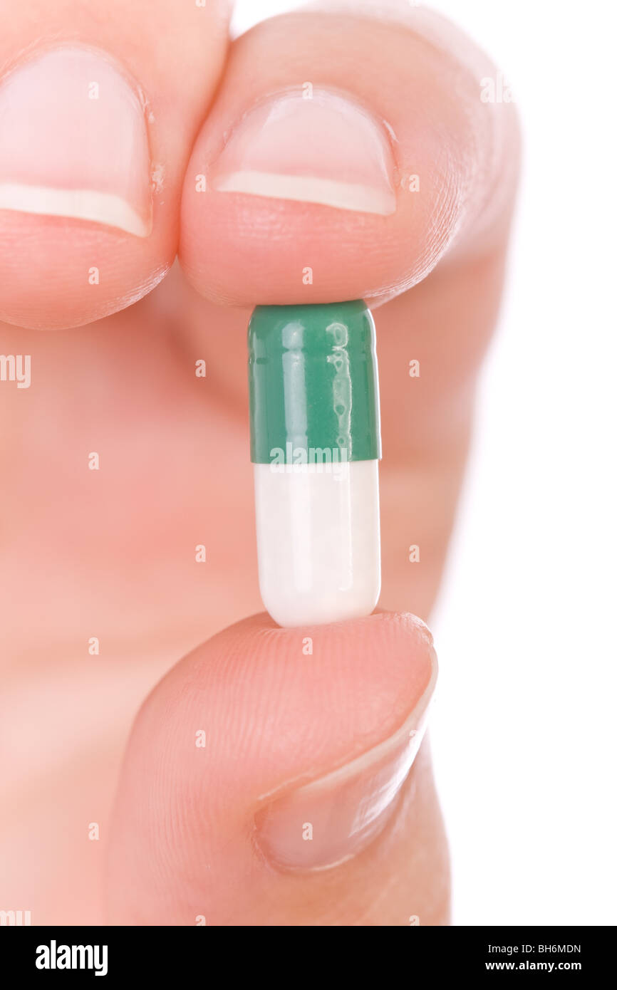 Hand holding a capsule or pill close up Stock Photo Alamy