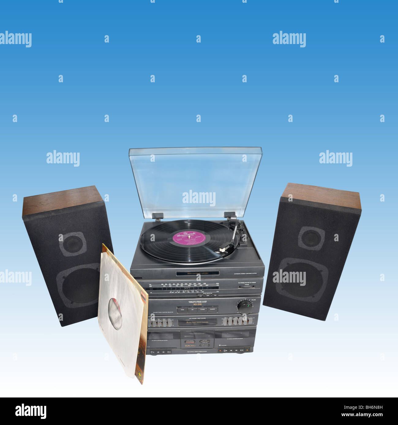 A stereo sound deck system with turntable,  speakers, and an LP with its cover. Stock Photo