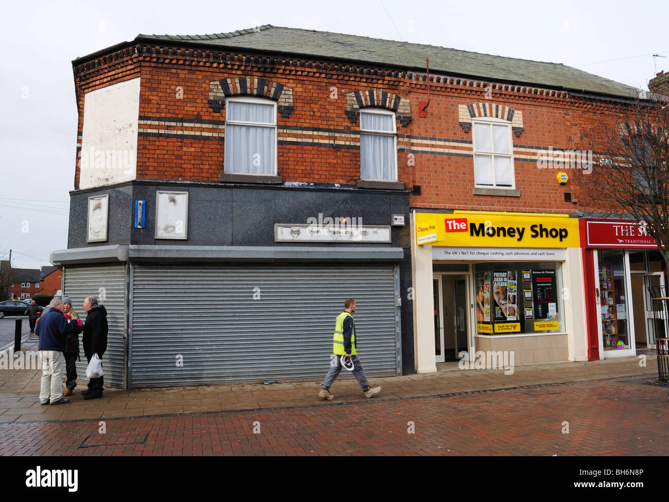 The newly opened Money Shop in Widnes, Cheshire, situated next to a closed and shuttered shop. Stock Photo