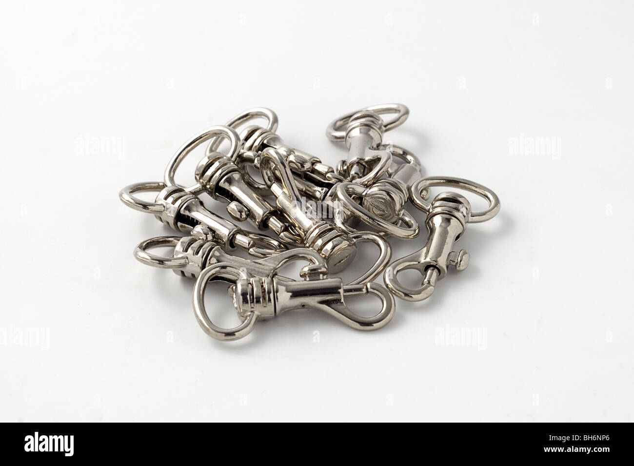 Small Nickel plated swivel hooks isolated against white Stock Photo
