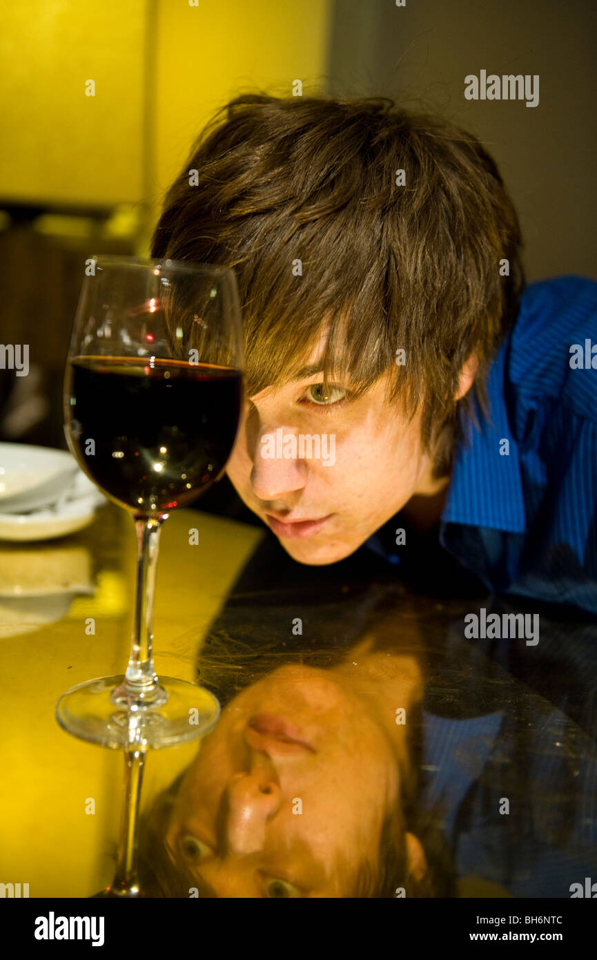 A young man drinking in a bar Stock Photo