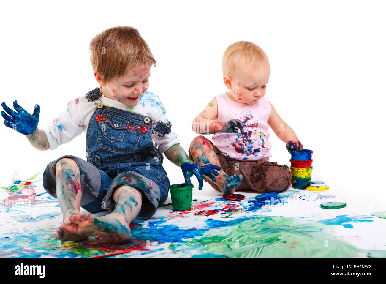 Two kids finger painting on white background Stock Photo