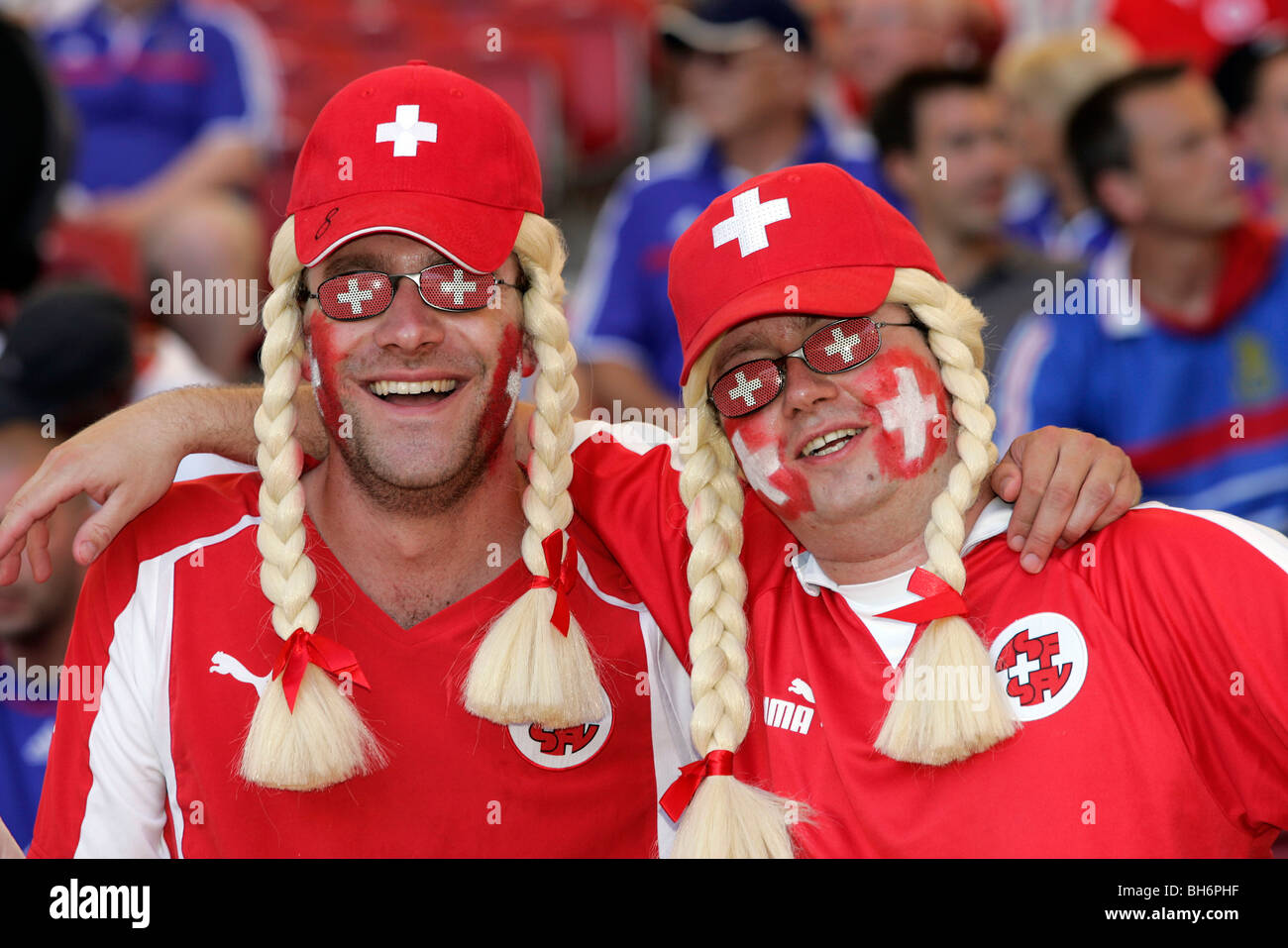 Swiss football fans with painted faces in the stands at the 2006