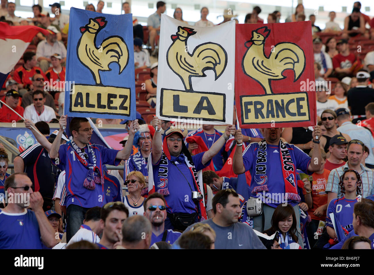 French football fans with banners sing in the stands at the 2006