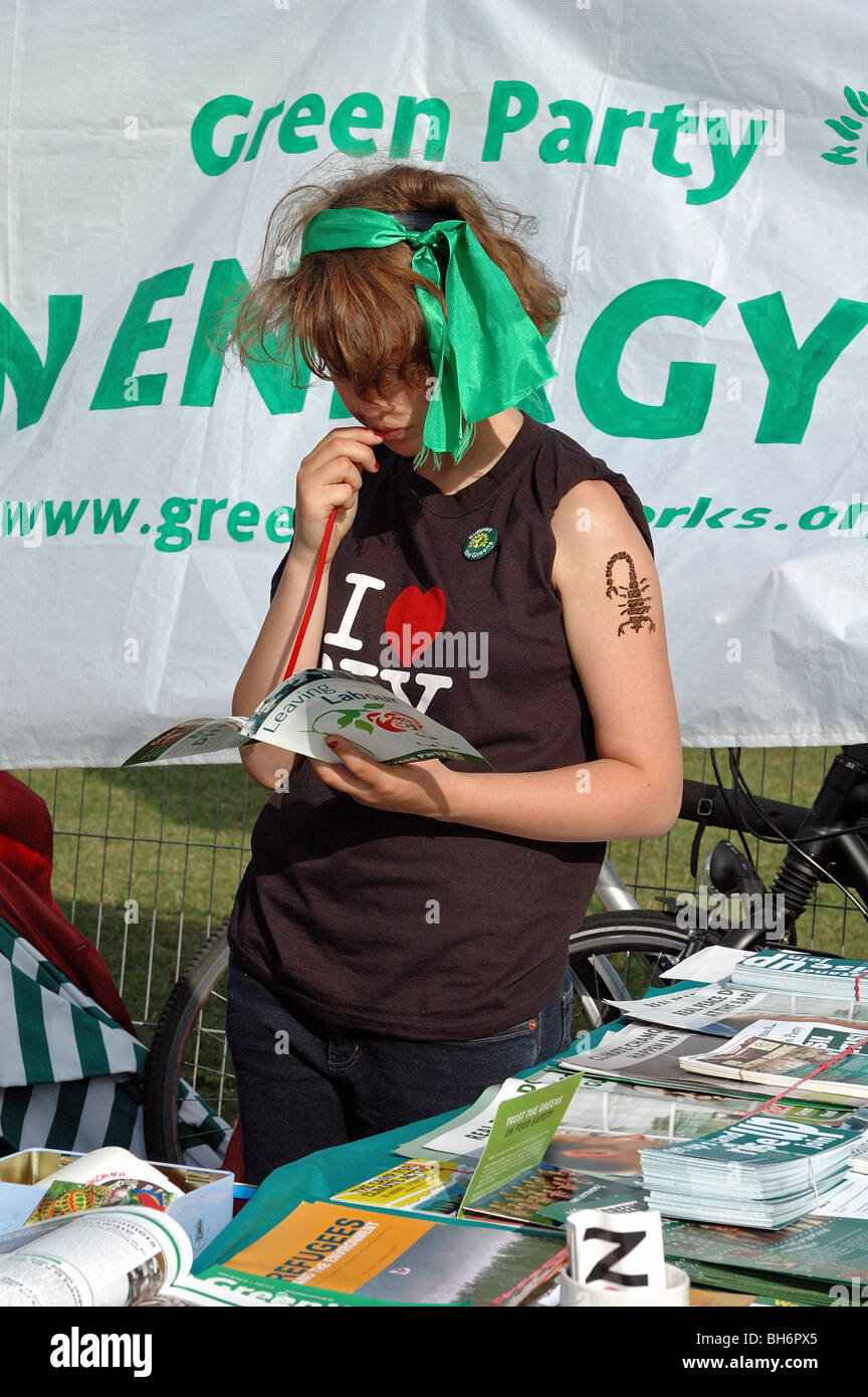 Young girl on Green Party stall with green ribbon in her hair, Rise