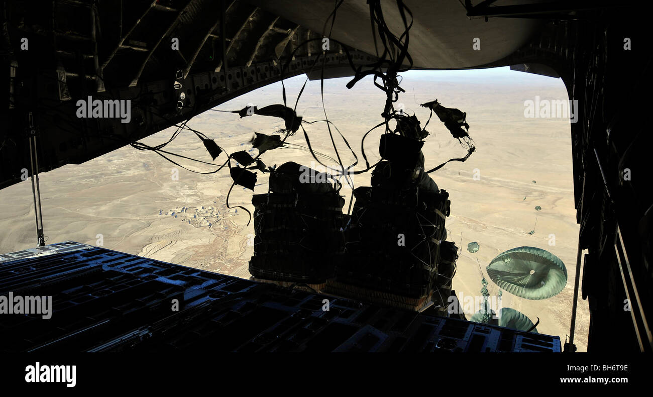 Container Delivery System bundles exit a C-17 Globemaster III during an airdrop mission. Stock Photo