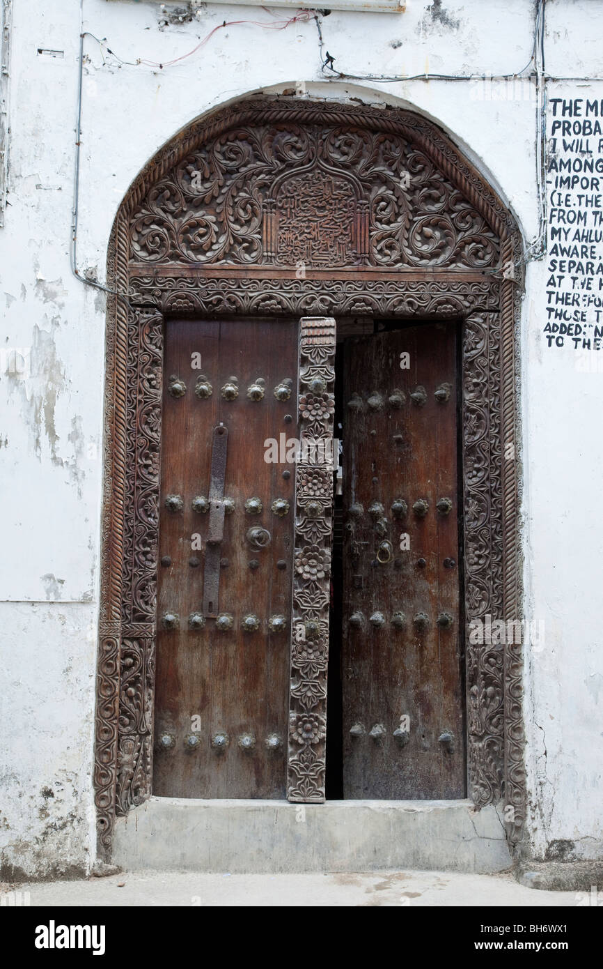 Stone Town, Zanzibar, Tanzania. Mosque Entrance, Indian-style Door. Arabic Calligraphy above the door. Stock Photo
