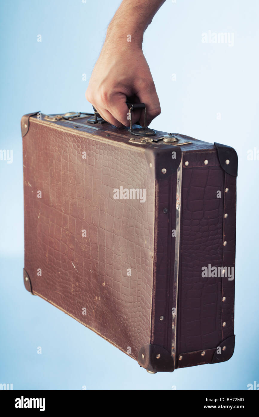Hand carrying an old suitcase Stock Photo Alamy