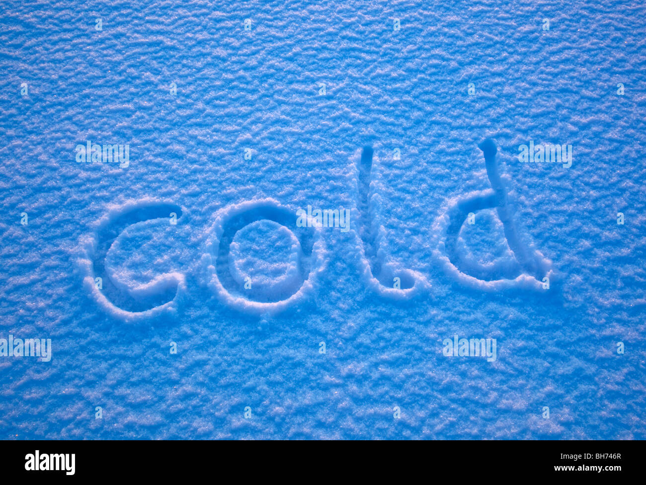 The word 'cold' spelled out in the snow. Stock Photo