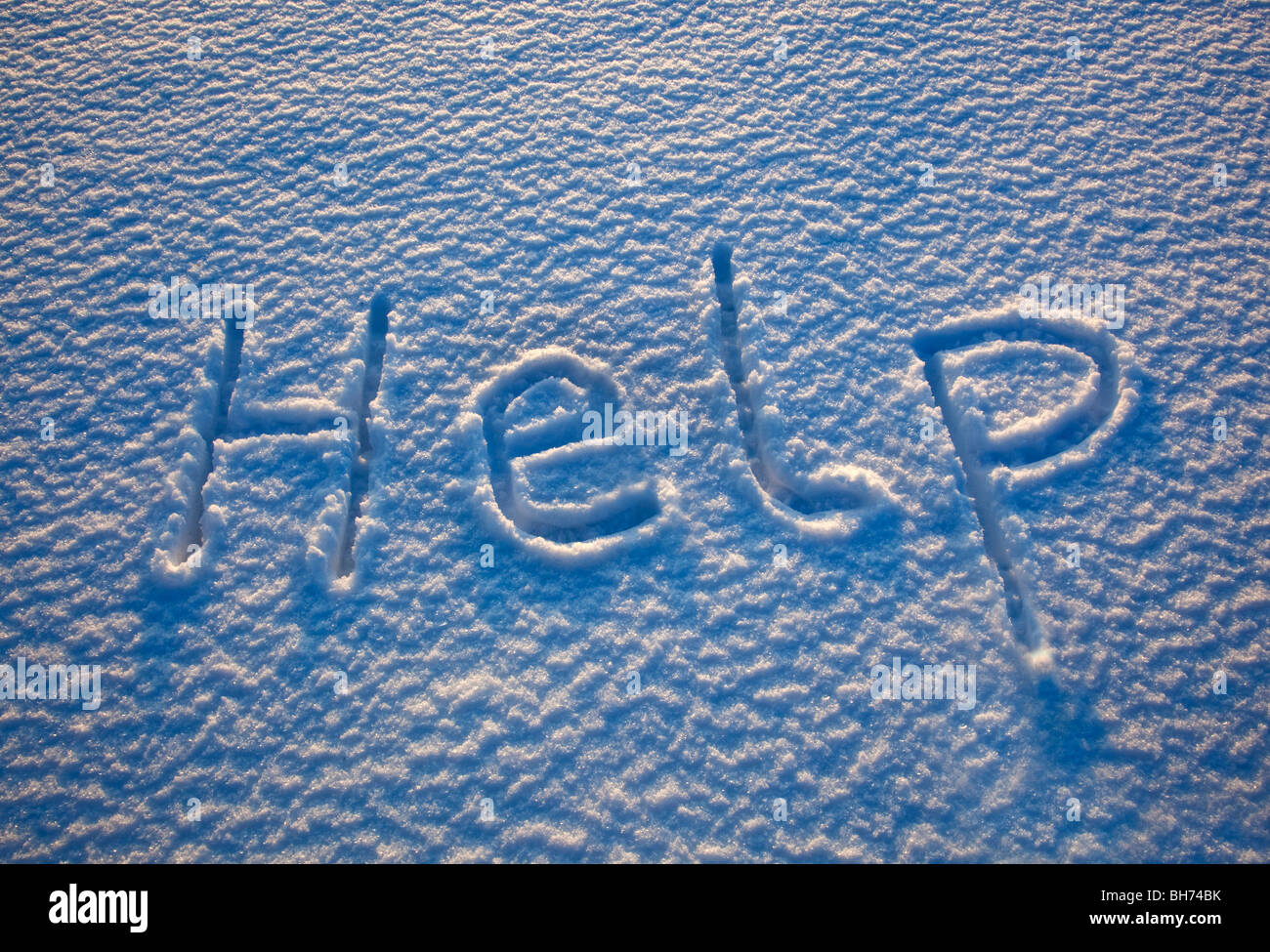 The word 'help' spelled out in the snow Stock Photo