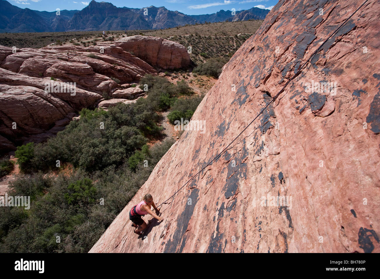 Woman rock climbing, Red Rocks National Monument, Nevada, USA Stock Photo