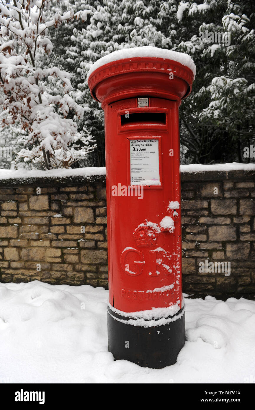 Red mailbox in the snow England Uk Stock Photo
