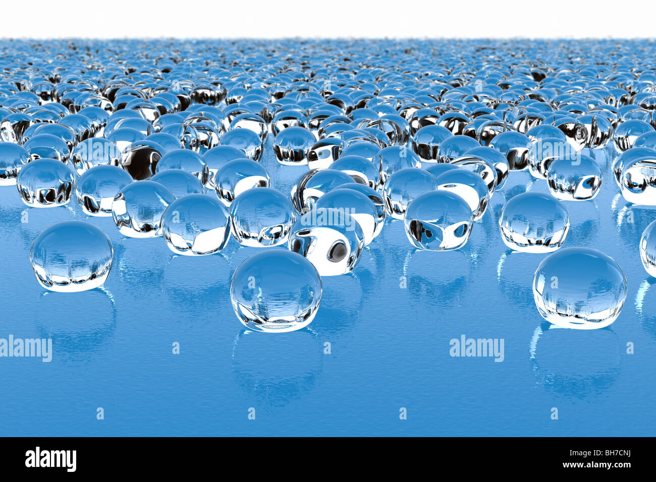 Thousands of glass drops on a wavy glass surface with reflections, refractions and a medium depth of field. Stock Photo