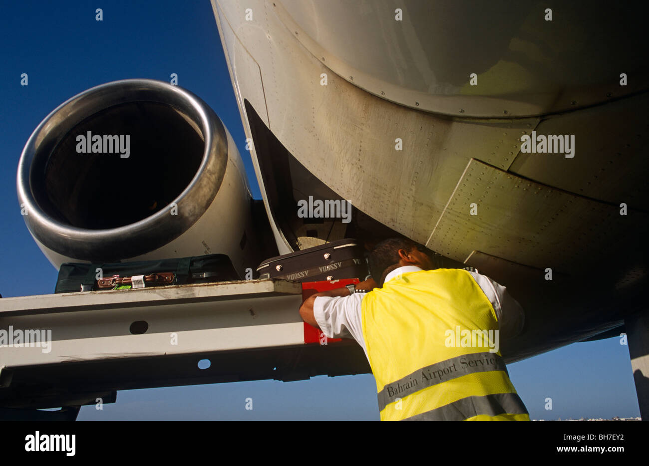 A Bahriani baggagehandler employed by SABTCO loads baggage at the Gulf