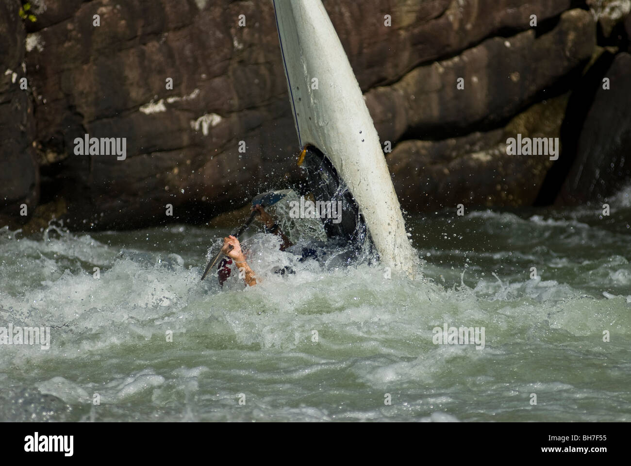 Kayaker turns his boat vertical in the river with the bow up at Pillow Rock Rapids, Gauley River, WV. Stock Photo