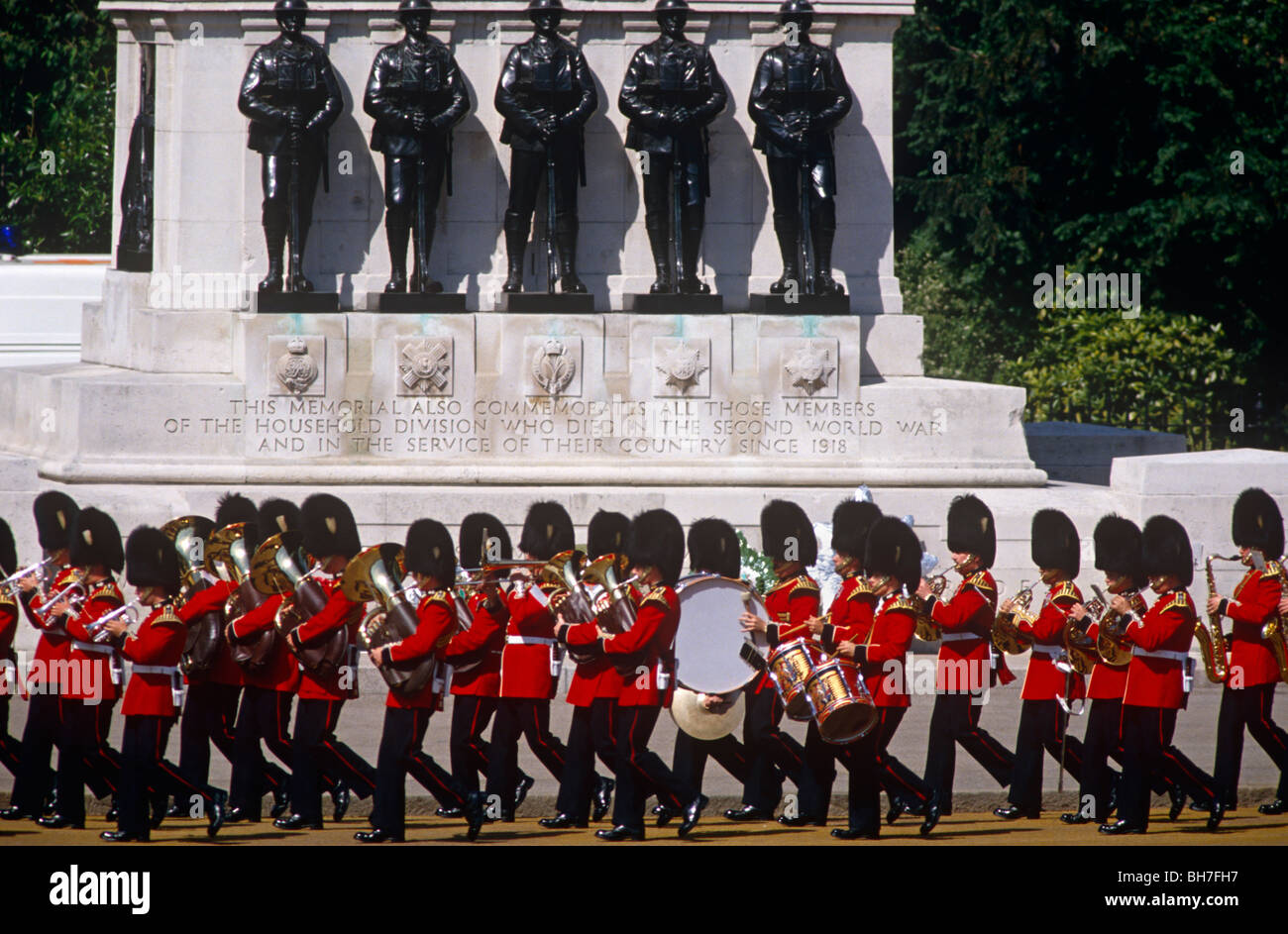 Marching grenadier bandsmen pass the war memorial in Horseguards Parade