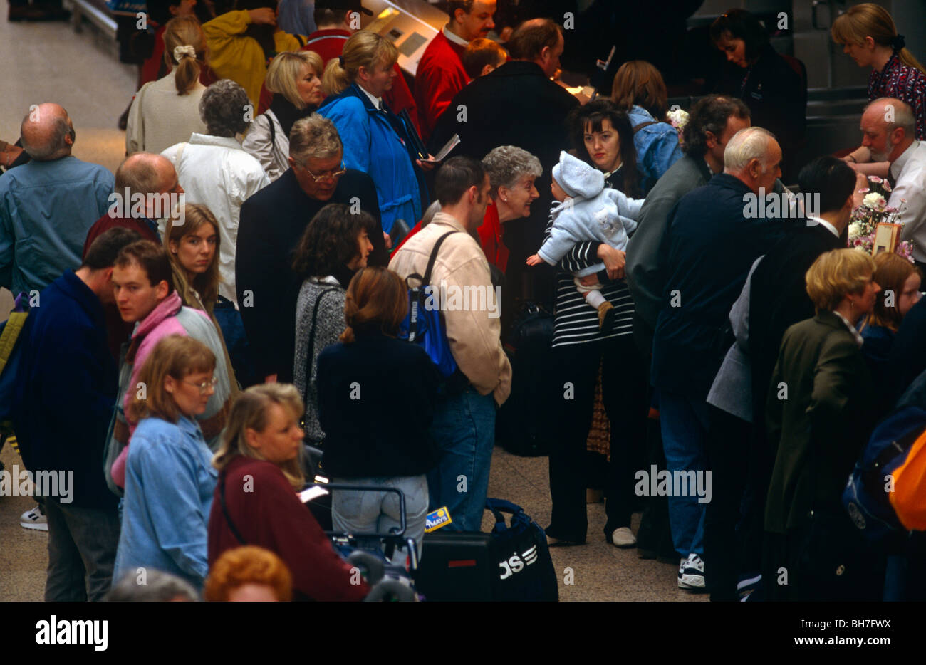 Crowds wait to check-in during a busy holiday weekend at Glasgow airport. Stock Photo