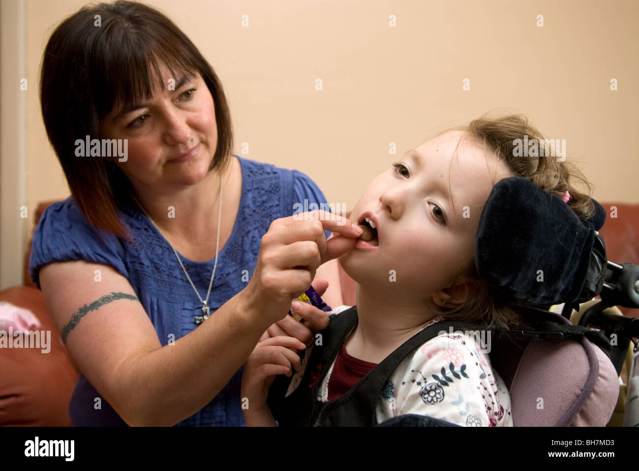 Working mother caring for her disabled daughter at home who suffers