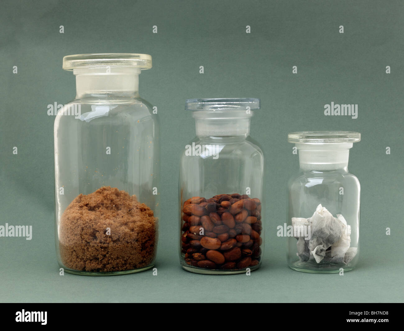 https://c8.alamy.com/comp/BH7ND8/three-glass-storage-jars-with-beans-tea-bags-and-brown-sugar-BH7ND8.jpg