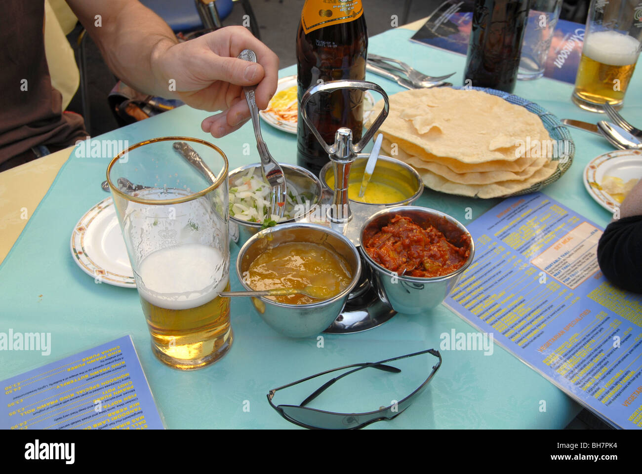 UK. Eating curry in the streets at the Brick Lane Curry Festival in