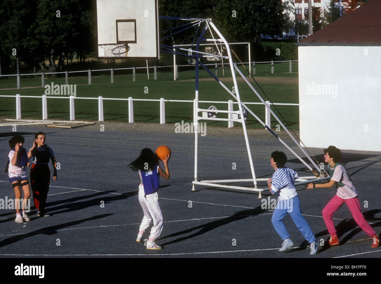 French girls playing basketball, students playing basketball