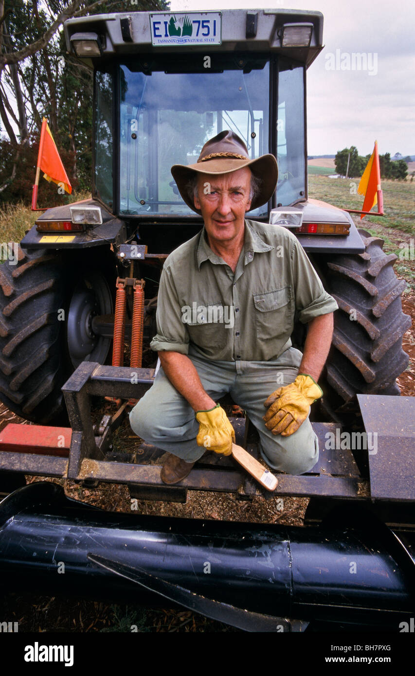 Farmer with cutter-mower, Tasmania Australia Stock Photo