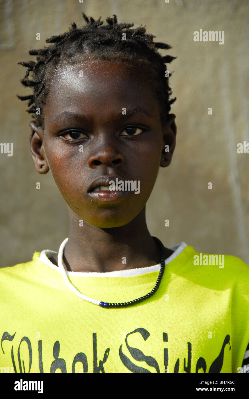 Young girl of the Bodi people of southern Ethiopia in chartreuse shirt. Stock Photo
