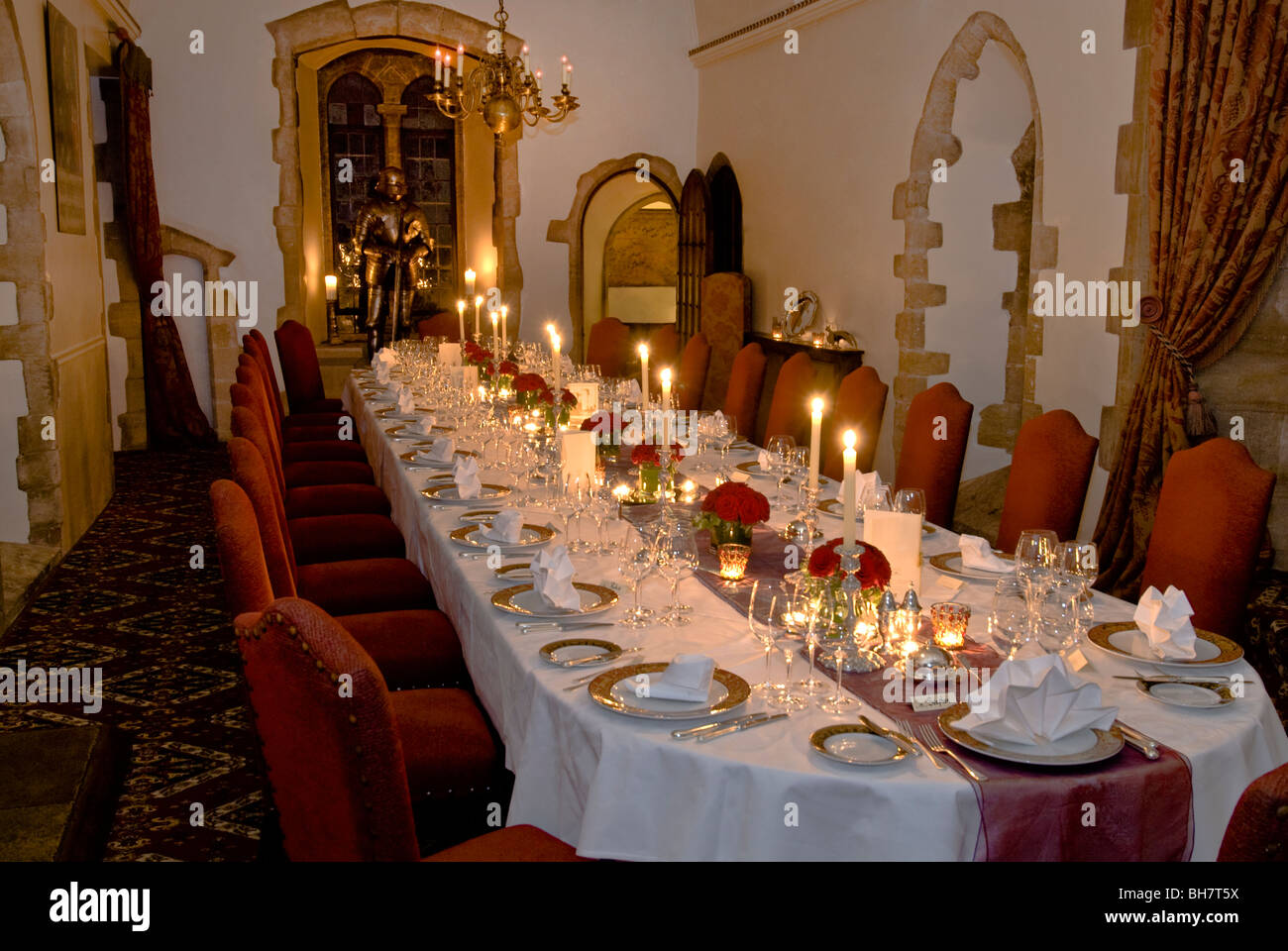 formal seated laid and prepared candlelit banquet dinner table in BH7T5X