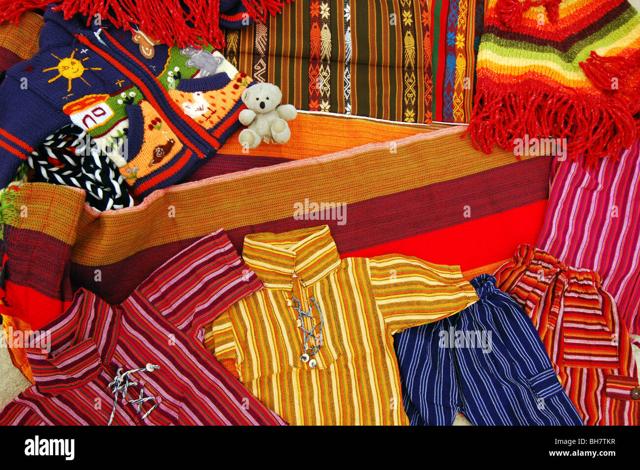 Ecuador, Otavalo, view of colorful textile materials (shirts, hammock
