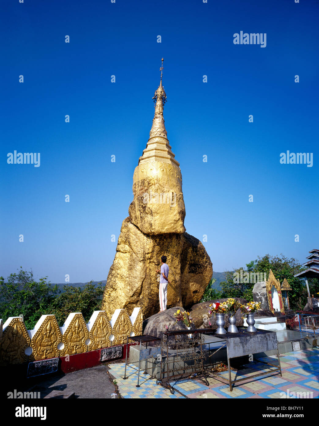 A man is standing in front of Nwa - La - Bo Pagoda also called little Kyaiktiyo  Golden Rock Myanmar Burma Stock Photo