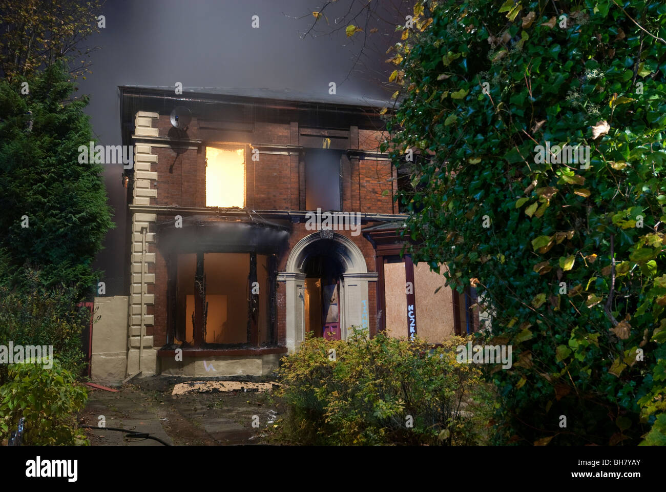 Large Edwardian house on fire at night Stock Photo